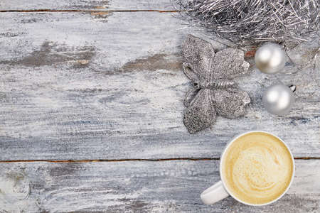 Cup of cappuccino with newspaper on the table, coffee shop background, warm toneの写真素材