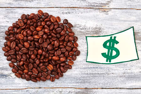 Heap of coffee grain. Currency painted on paper.の写真素材
