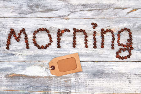 Paper card near coffee beans. Morning from coffee beans, table.の写真素材