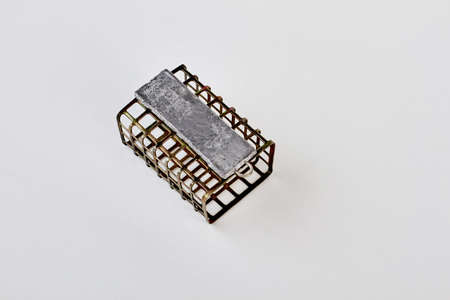Metal fishing feeder, top view. Steel feeder, cargo, white background. Accessories for fishermen.