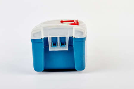 Blue fishing tackle box isolated. Plastic portable container, white background.の写真素材