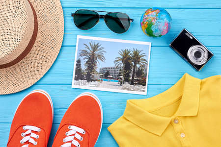 Travel clothing stuff, wooden board. Concept of summer vacation, essential items.の写真素材
