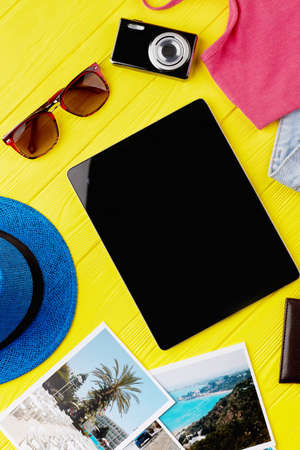 Modern electronic black gadget. Summer accessories on colorful background. Concept of sunny...