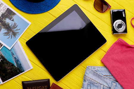 Modern electronic computer tablet with internet. Travel accessories collection, wooden background....