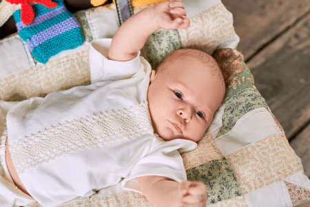 Caucasian baby boy. Kid lying on a blanket. Children need love.の写真素材