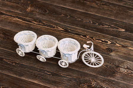 Tricycle flower basket. Tiny wicker baskets with bows.の写真素材