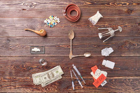 Still life of narcotic preparations. Image of clock from drugs.