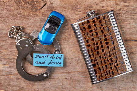 Handcuffs, toy car, message, hip flask. Habit drink and drive leads to hard punishment.の写真素材
