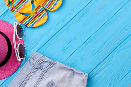 Set of beach accessories, blue background. Concept of summer trip.の写真素材