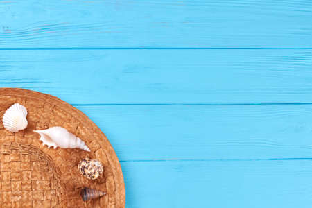 Summer holiday travel background. Straw hat, sea shells, blue space.の写真素材