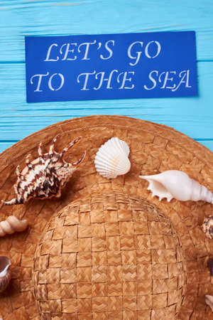 Straw hat, shells close up. Summer ocean resort background.の写真素材