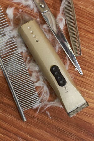 Animal grooming tools set. Hair clipper, comb and scissors.