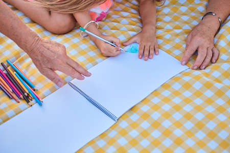 Hands of child drawing. People, paper and pencils.の写真素材