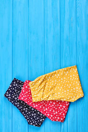 Natural baby clothing and copy space. Top view of new folded baby girl summer trousers on sale. Summer childs clothes in vintage print.の写真素材