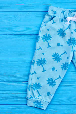 Cropped image of modern baby leggings. Close up of printed fashion spring pants for children. Trendy clothes for kids.の写真素材