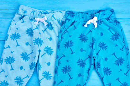 Beautiful baby fashion colored clothing. Fashionable spring or autumn baby trousers on sale. Kids modern outfit.の写真素材