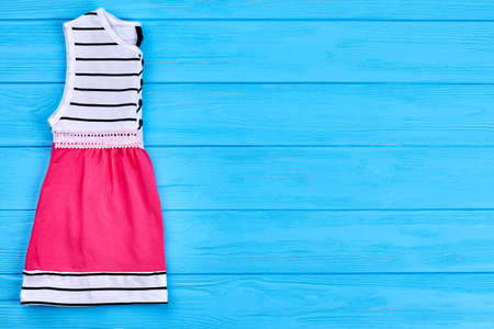 New folded fashion dress for baby. Cute organic baby-girl summer apparel and copy space. Infant girl summer outfit.の写真素材