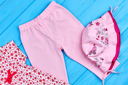 Pink leggings and hat for baby-girl. Beautiful cotton apparel for toddler girl, top view. Infant girl summer outfit.の写真素材