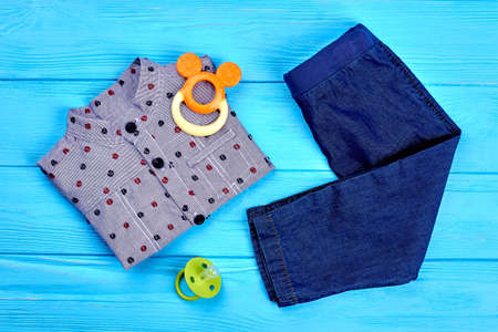 Clothes and accessories for baby-boy. Top view of new folded autumn apparel for infant boys. Trendy kids garment and accessories.の写真素材