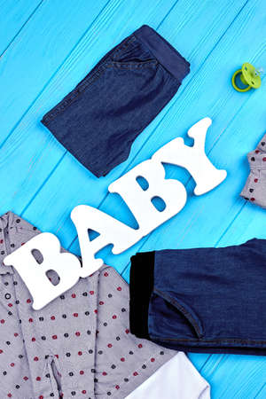 Top view of baby-boy fashion clothes. Word baby and kids garment for autumn wear. Setting of high quality clothes for infant boys.の写真素材