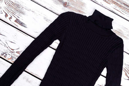 Turtleneck striped black sweater. Warm thick knitted winter sweater on vintage background. Winter knit wear.の写真素材