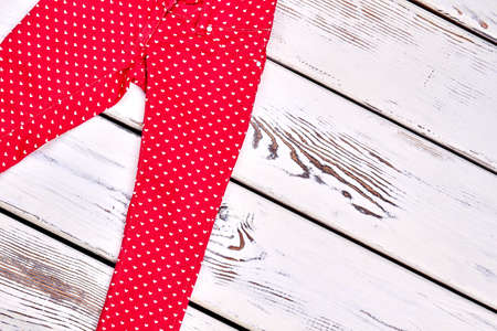 Girls new skinny colored trousers. Super skinny colored patterned jeans for girls, white wooden background.の写真素材