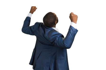 Back view of elated manager. Joyful afro businessman celebrating achievement. Young excited business person.の写真素材