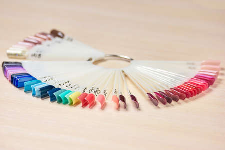 Samples of color nail polish. Palette examples of nail polish variety. Professional salon of nail art.の写真素材