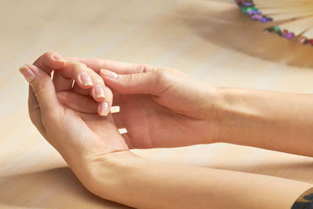 Beautiful woman hands in nail salon. Female hands in beauty salon ready for manicure. Caucasian woman clean and gentle hands on salon table.の写真素材