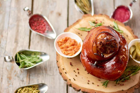 Appetizing restaurant dish close up. Beutifuly served shank of lamb on natural wood close up. Dinner in restaurant.の写真素材