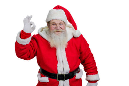 Cheerful Santa Claus man showing ok sign. Happy senior Santa Claus with ok sign on white background....