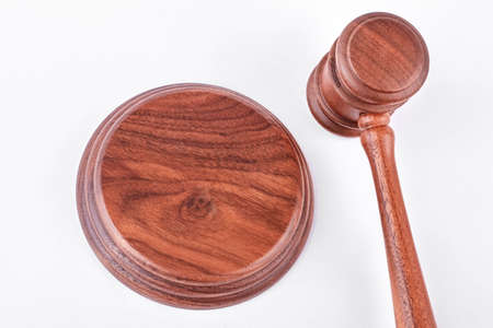 Wooden judge gavel and wooden stand. Judge gavel and stand isolated on white background.