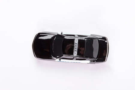 Police car toy, top view. Black plice car toy isolated on white background. Defend and security concept.の写真素材
