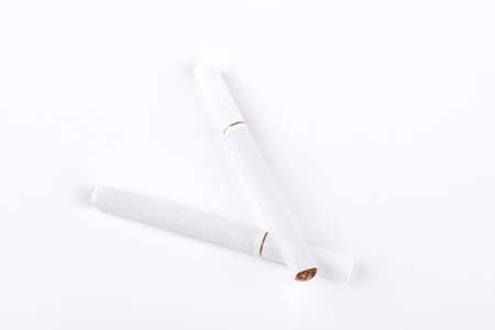 Two white cigarettes on white background.の写真素材