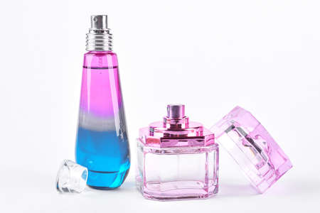 Two fashion glass perfume bottles. Ombre and pink open bottles of female perfume isolated on white background. Woman toiletry and fragrance.の写真素材