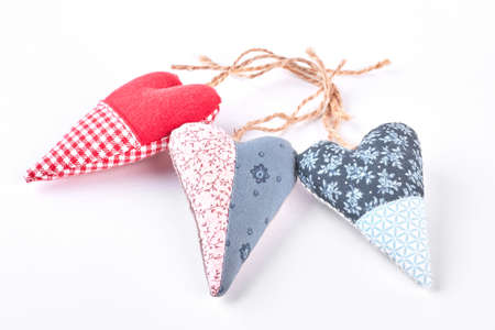 Textile handicraft isolated on white background. Set of fabric handmade hearts.