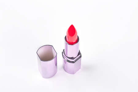 Red lipstick over white background. New brand lipstick in glamour container isolated on white background. Female beauty and style.の写真素材