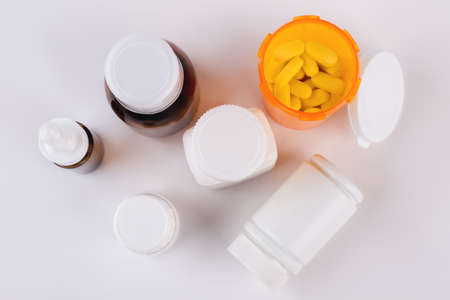 Antipyretic syrup, nasal spray, pills. Composition of medicine bottles and pills on white background, top view.の写真素材