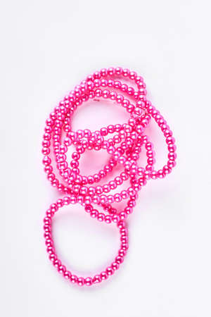Pink plastic nacklace on white background. Beautiful beads necklace isolated on white background.の写真素材