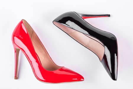 Leather lacquered female high heels. Woman classic red and black shoes on high heels isolated on white background. Female fashion and elegance.の写真素材