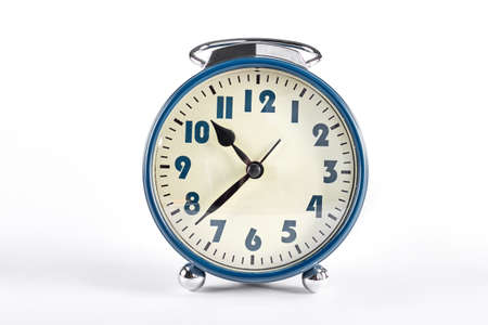 Classic retro alarm clock. Old fashioned alarm clock isolated on white background.の写真素材