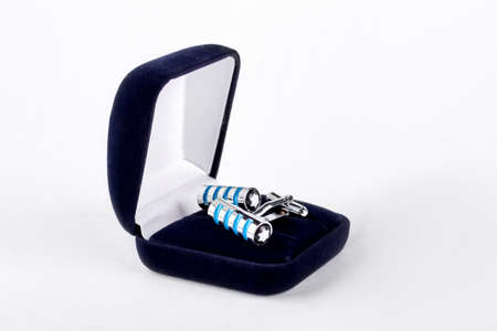Pair of cuff links in velour box. Silver and blue wedding cuff links in velour box isolated on white background. Men elegance and style.の写真素材