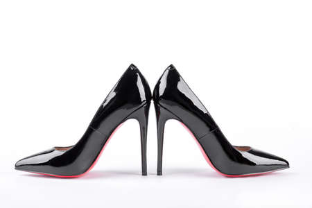Lacquered heeles with red soles. Black leather louboutin isolated on white background. Woman fashion outfit.の写真素材