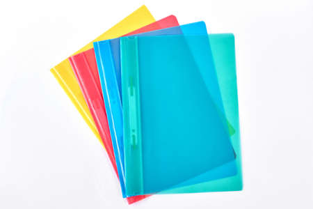 Multicolored transparent folders for documents. Four different colors file folders isolated on white...
