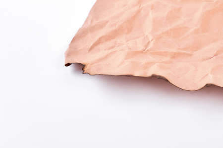 Aged sheet of paper with burnt edge. Torn sheet of brown ancient paper isolated on white background. Old paper damaged with fire.の写真素材