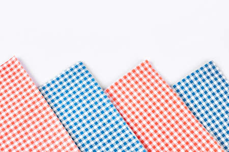 Plaid table napkins, white background. Collection of red and blue checkered tablecloth on white background close up. Row of vintage table napkins.の写真素材