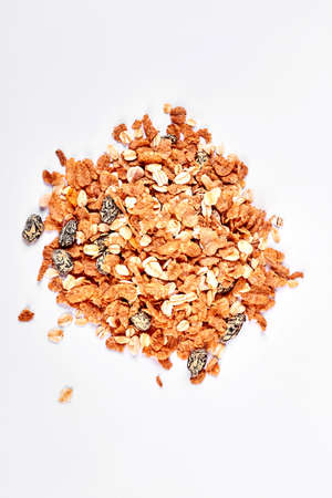 Pile of oat flakes with raisins. Oat flakes isolated on white background, top view.の写真素材