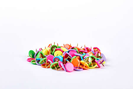 Pile of multicolored push pins. Heap of colorful push pins isolated on white background. Variety of push pins of different colors.の写真素材