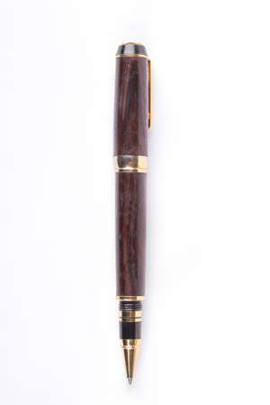 Brown ballpoint pen on white background. Wooden and gold ballpoint pen isolated on white background. Luxury gift on teacher day.の写真素材