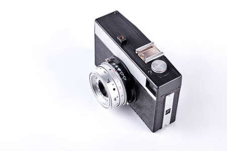 Old film camera, top view. Black and grey soviet photo camera isolated on white background.